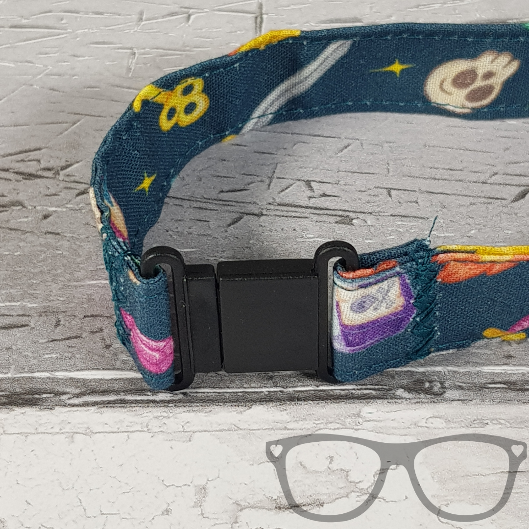 Teal Fantasy RPG Lanyard, teal fabric with colourful fun fantasy iconography in a pattern. The lanyard features a lobster style clip for your keys or ID Card, and a quick release safety clip