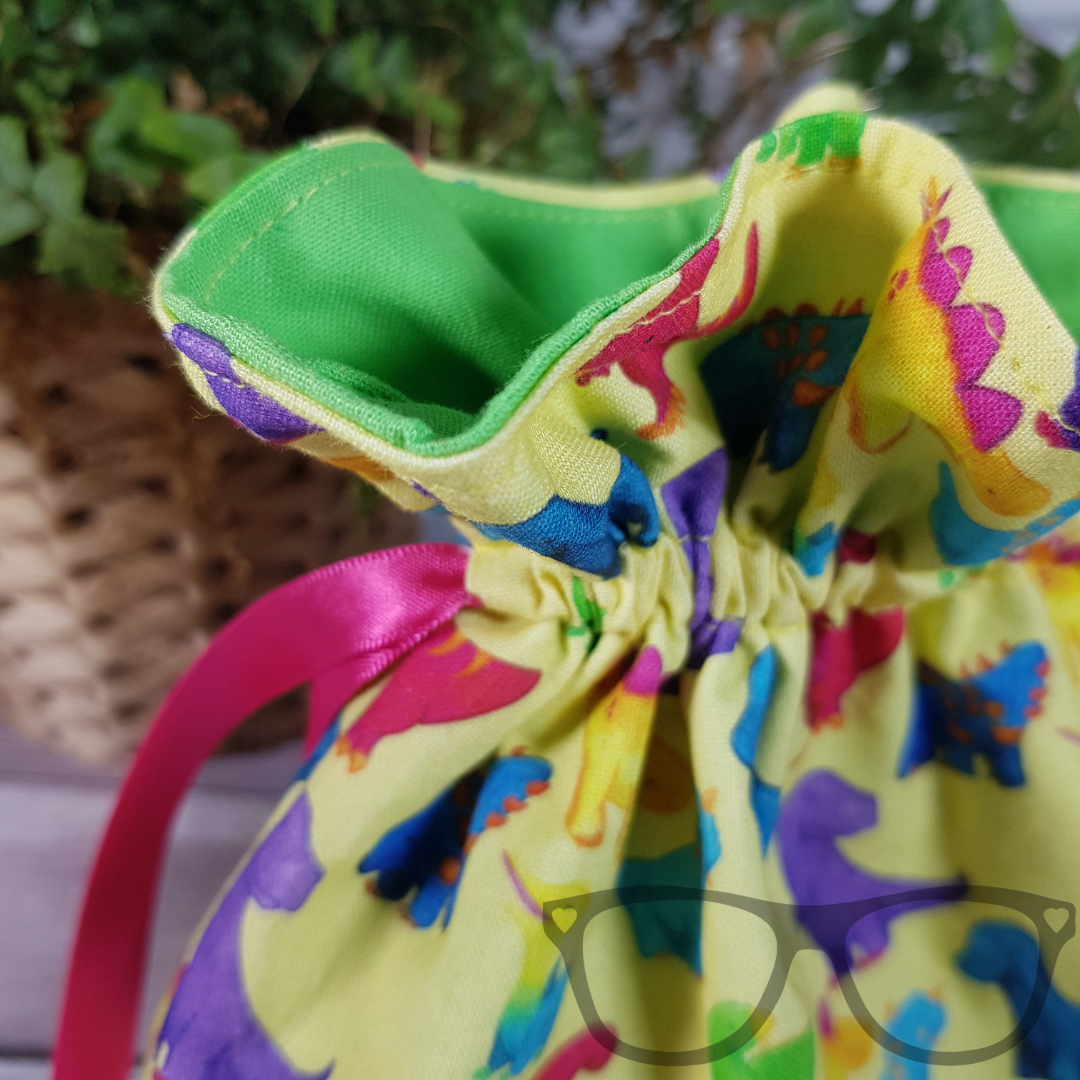 Close up showing detail of the dinosaur drawstring bag