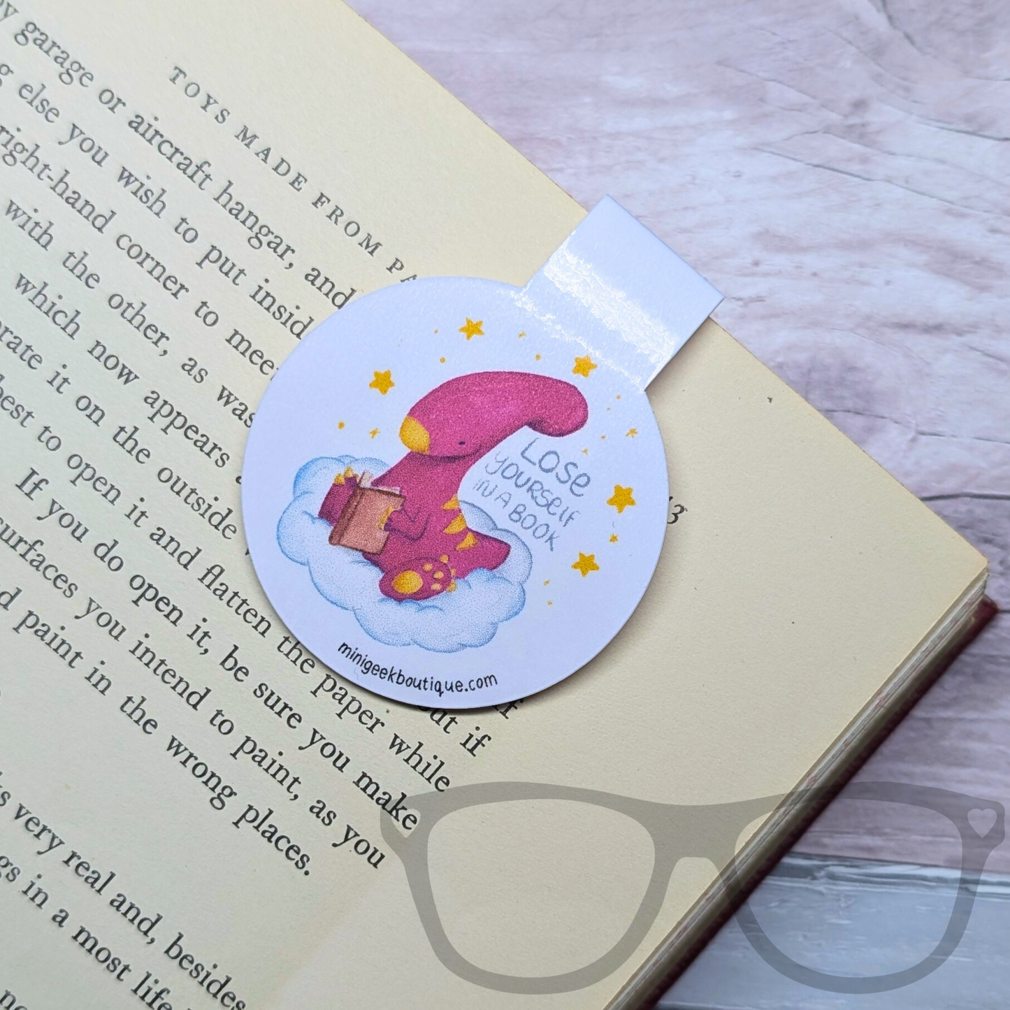 Close-up view of the gloss laminated magnetic bookmark with Irene the Parasaurolophus. Durable, fold-over design keeps pages marked securely without damage.