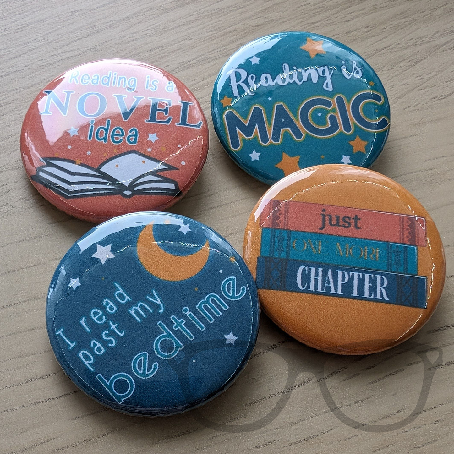 Set of 4 38mm badges ideal for lovers of books and reading. Text reads "Reading is a novel idea", "Reading is magic", "I read past my bedtime",  "Just one more chapter"