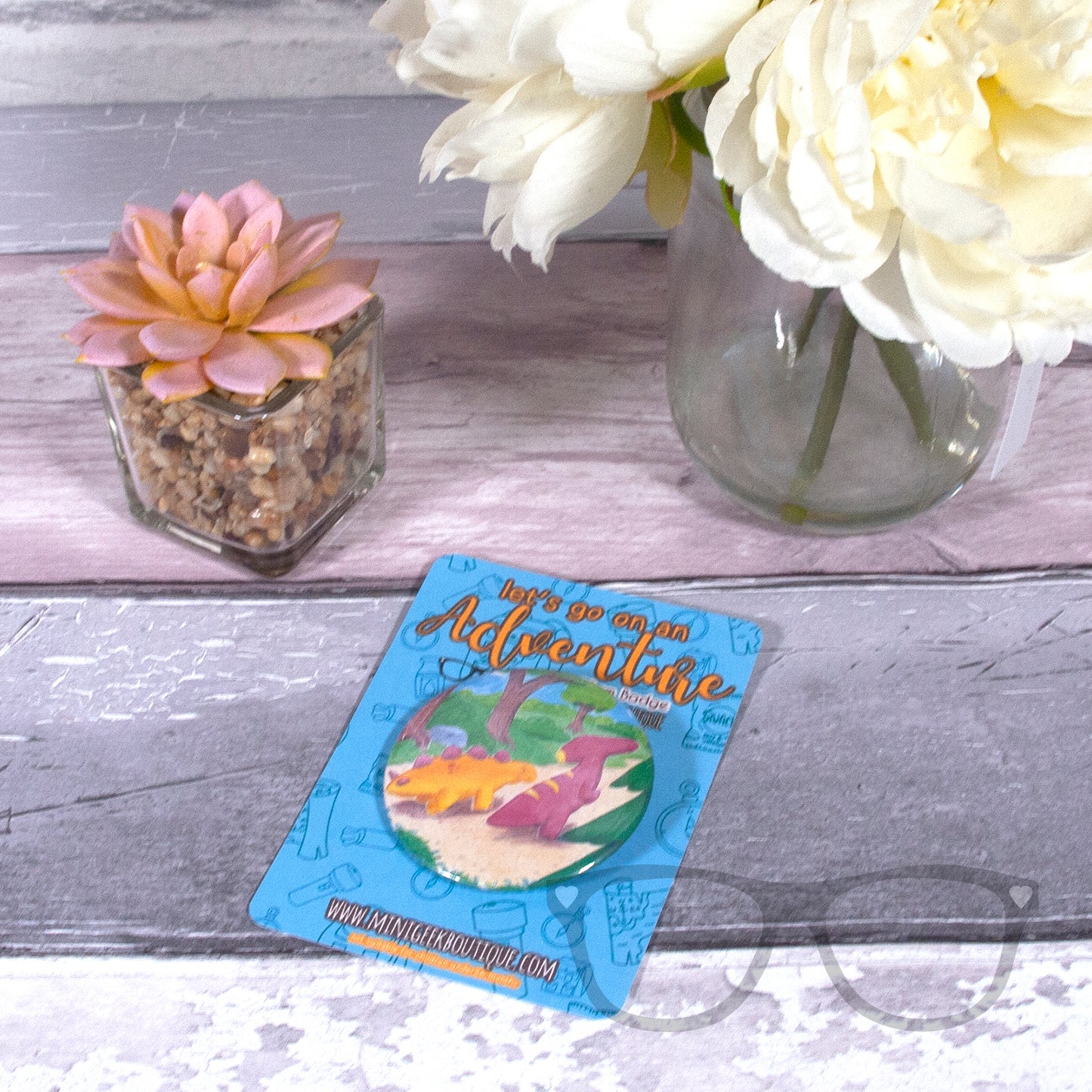 This 58mm badge shows the illustration of Derek and Irene the dinosaurs starting off on their adventure.