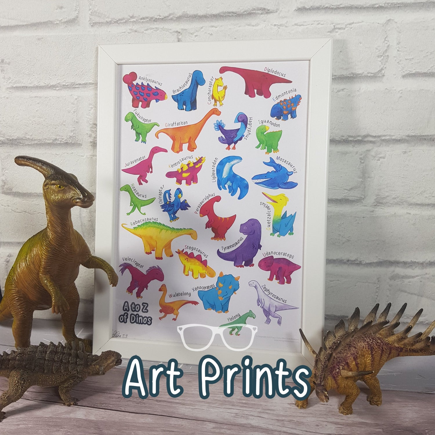 A framed A to Z of dinosaurs art print with Derek, Irene and Hank looking proud