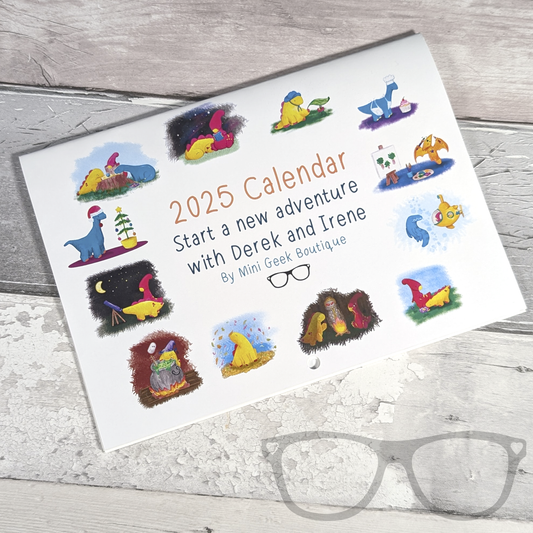 White A5 landscape calendar with dinosaur illustrations, showing the front cover. The text reads "2025 calendar, start a new adventure with Derek and Irene by Mini Geek Boutique"