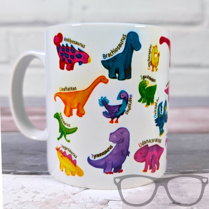 white ceramic mug with vibrant illustrations of dinosaurs for every letter of the alphabet