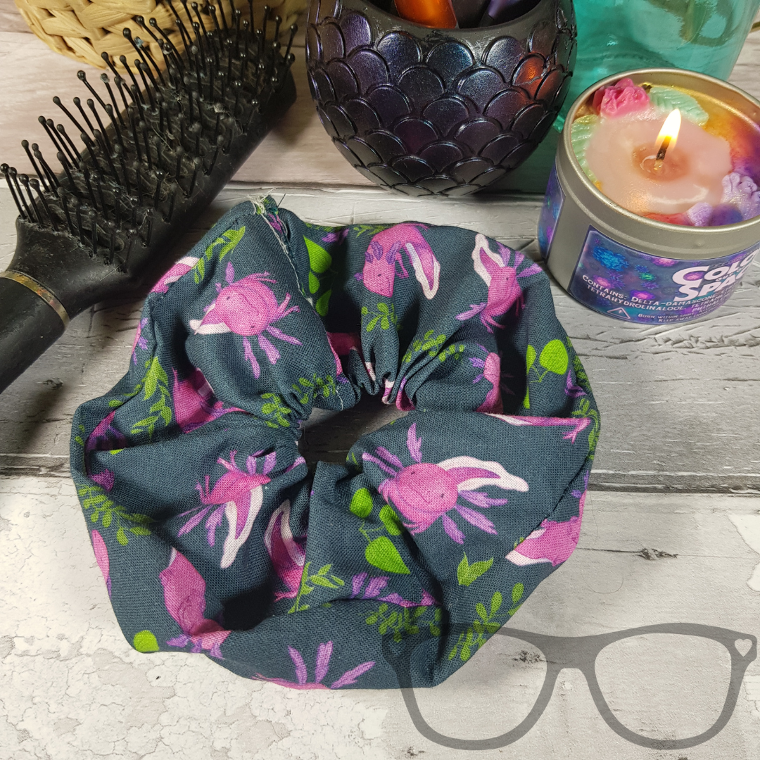 Pink Axolotl pattern on a dark green background handmade scrunchie