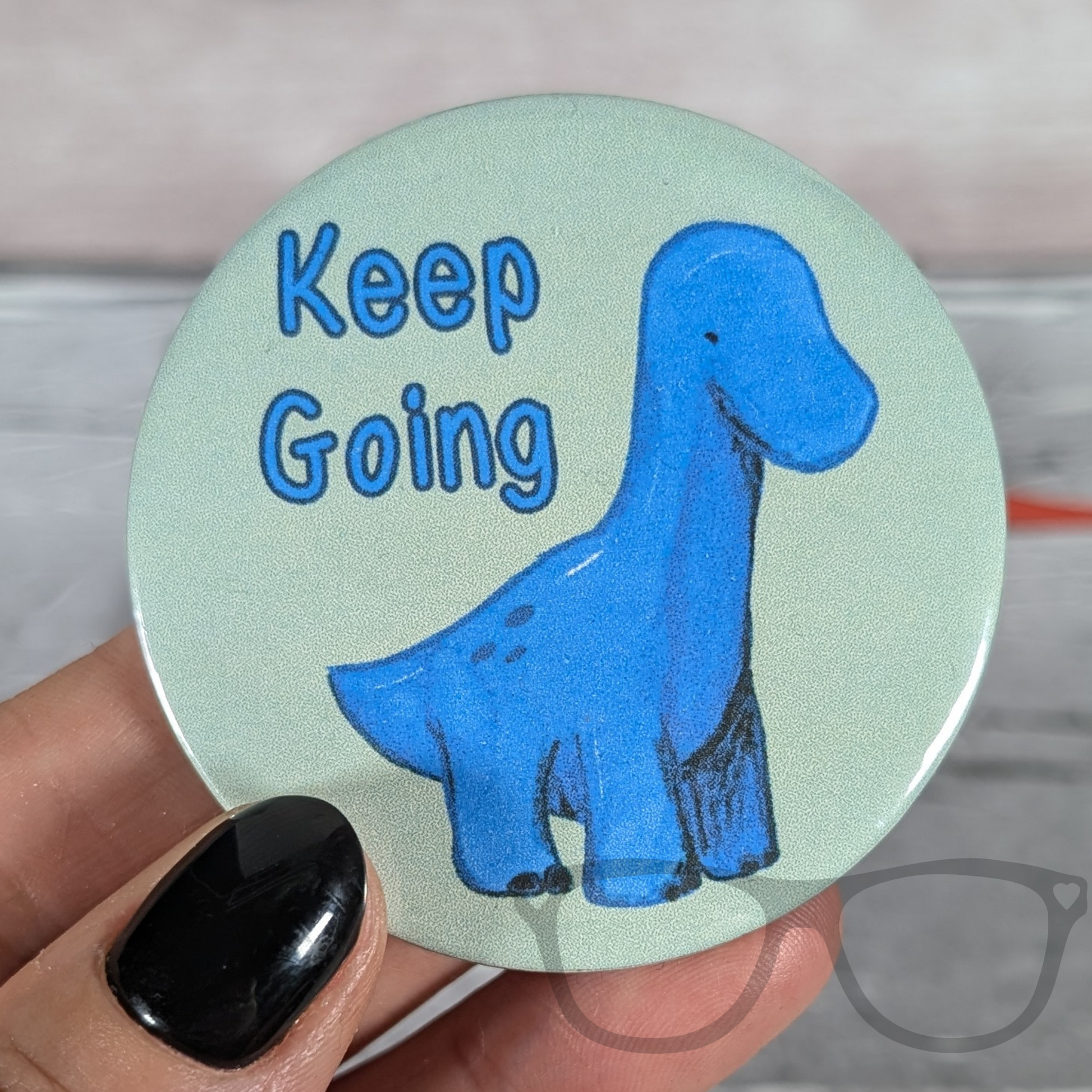 Brenda the Brachiosaurus Keep going badge being held