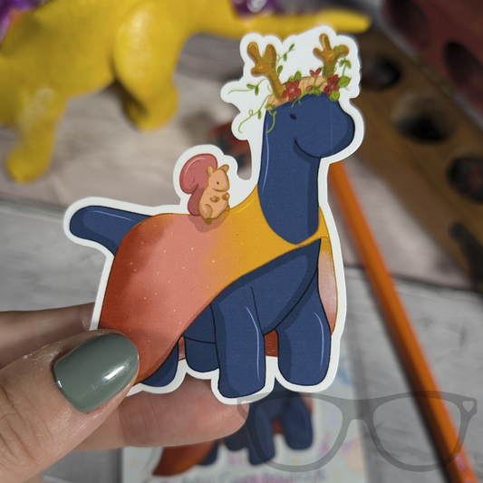 Brenda the druid Brachiosaurus vinyl sticker being held to show scale