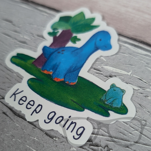 Close-up of the 'Keep Going' vinyl sticker featuring Brenda the Brachiosaurus. A cheerful reminder to stay positive!