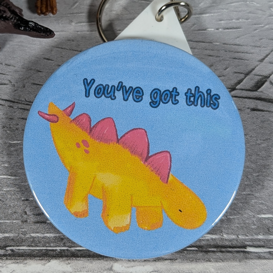 Derek 'You've got this' 58mm dinosaur keyring with motivational text, perfect for geeky gifts and positive reinforcement.