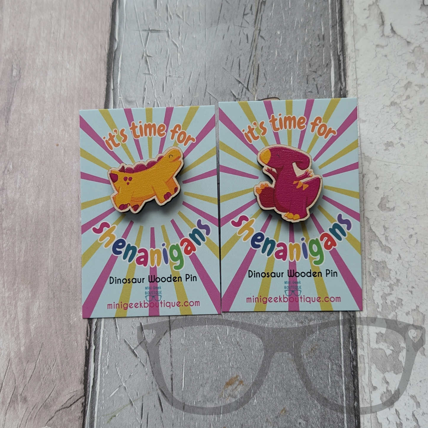 Derek the stegosaurus and Irene the Parasaurolophus wooden pin pair on backing cards