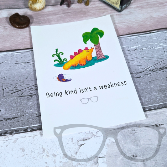 Derek the Stegosaurus dinosaur kindness postcard with the quote 'Being kind isn't a weakness.' Features a vibrant spot illustration of Derek, the dinosaur, with a positive message.