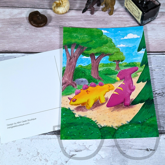 Dinosaur-themed illustrated postcard showing the glossy art print on the front and the writable matte back for messages and addresses. A6 size