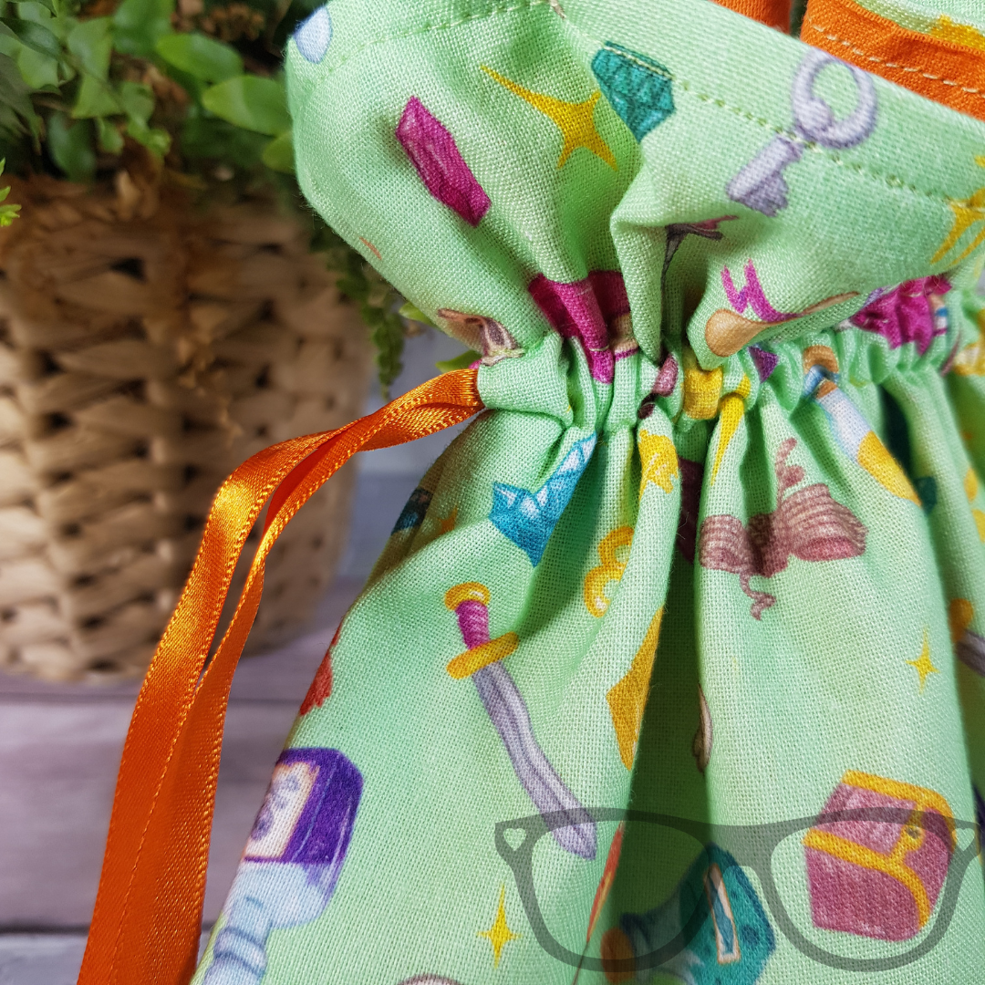 Close up of the light green fantasy genre drawstring bag, ideal for carrying your dice into the next adventure!#