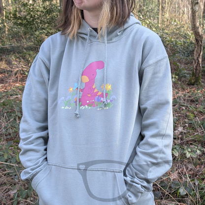 A full view of the dusty green hoodie showcasing the Irene the Parasaurolophus spring design. This soft and comfortable dinosaur hoodie is perfect for geeks and dino fans of all ages