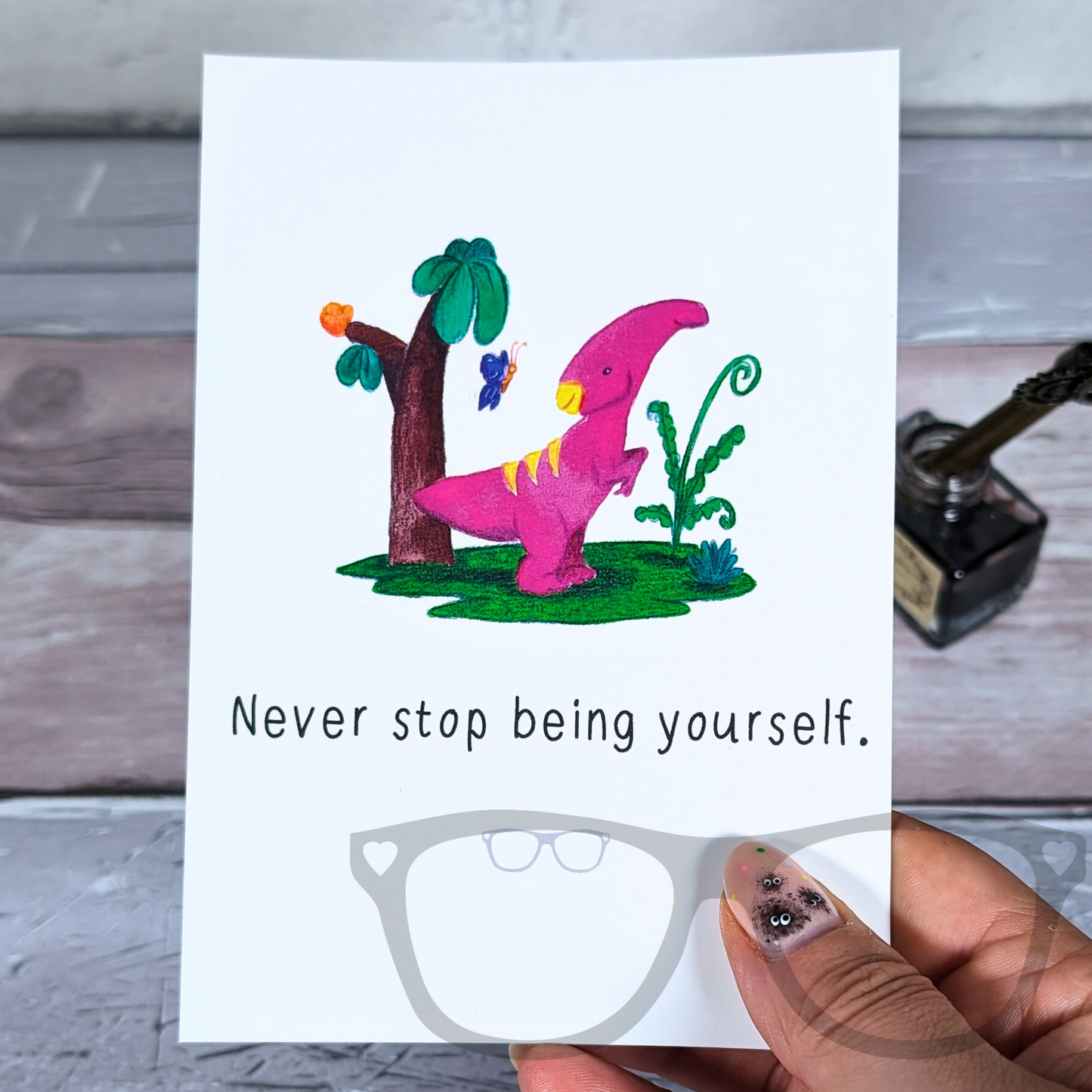 A6 sized postcard of Irene the pink Parasaurolophus with the text "Never stop being yourself"