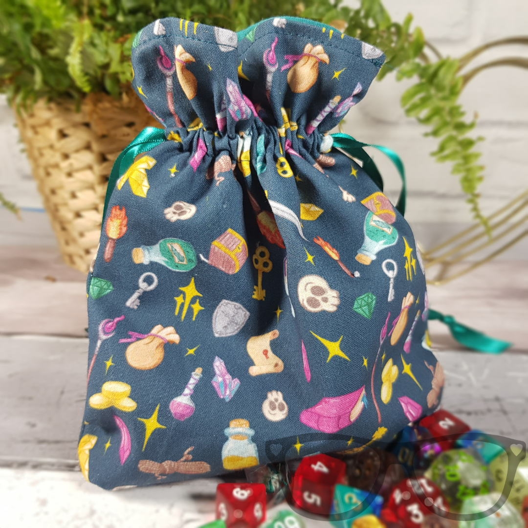 Teal Drawstring bag ideal for carrying dice, minis, snacks and little trinkets. Teal fabric with icons of fantasy genre, lined with a go-ordinating green fabric and secured using a green ribbon