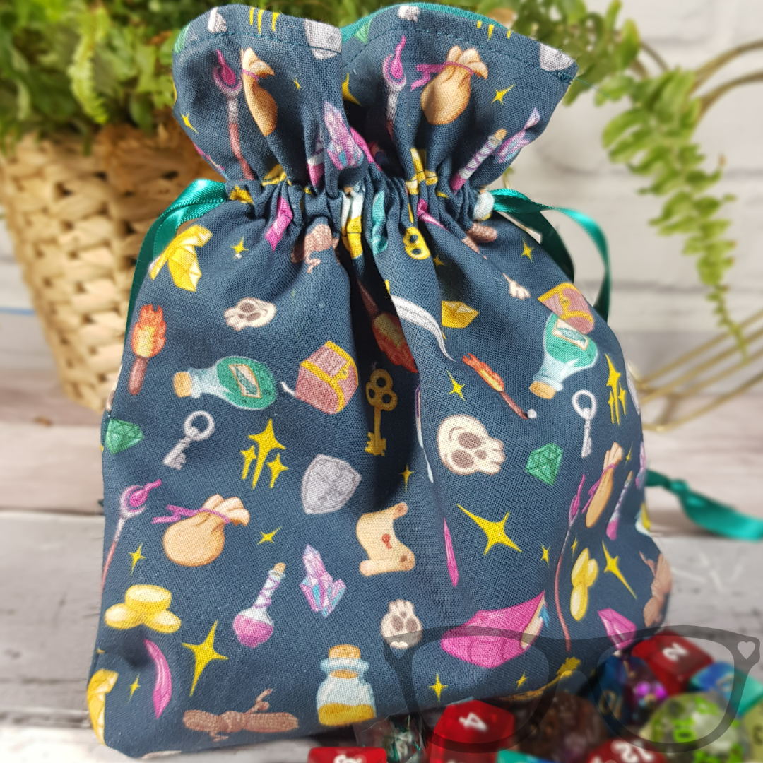 Teal Drawstring bag ideal for carrying dice, minis, snacks and little trinkets. Teal fabric with icons of fantasy genre, lined with a go-ordinating green fabric and secured using a green ribbon