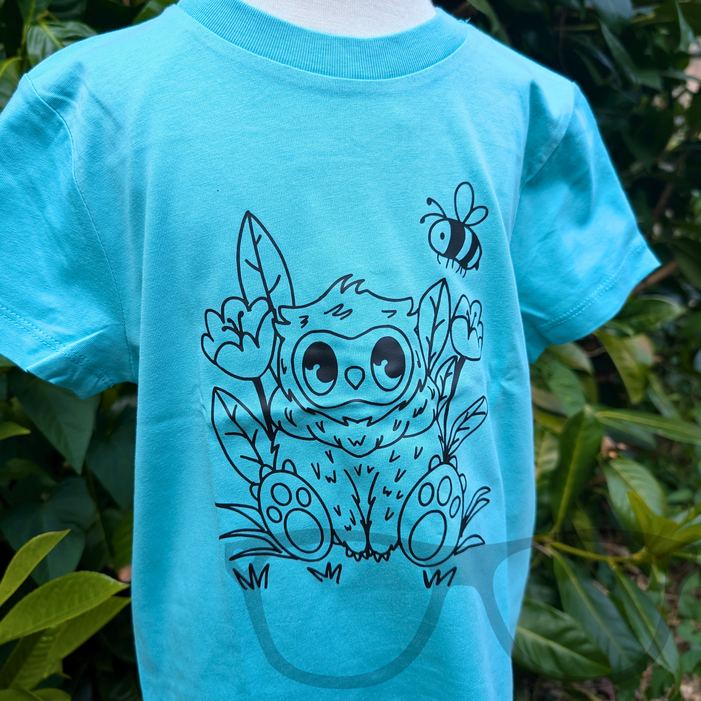 Blue T-shirt showcasing the black outline vinyl Owlbear design from a different angle, highlighting the detailed heat-pressed illustration on organic cotton fabric. Perfect for fans of fantasy creatures and tabletop games.