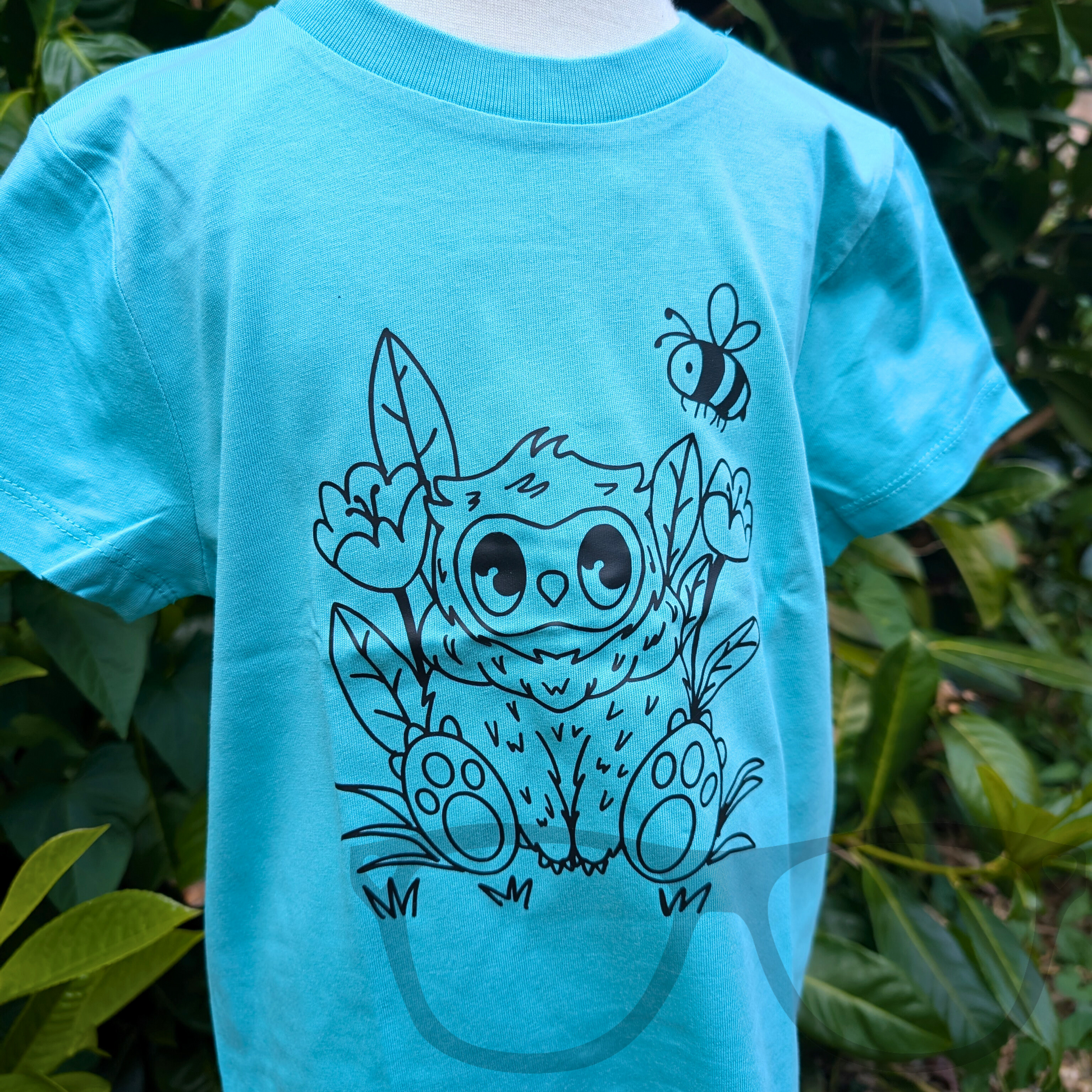 Blue T-shirt showcasing the black outline vinyl Owlbear design from a different angle, highlighting the detailed heat-pressed illustration on organic cotton fabric. Perfect for fans of fantasy creatures and tabletop games.