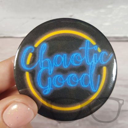 Chaotic Good Black button badge with neon light style design, features blue text and a yellow circle