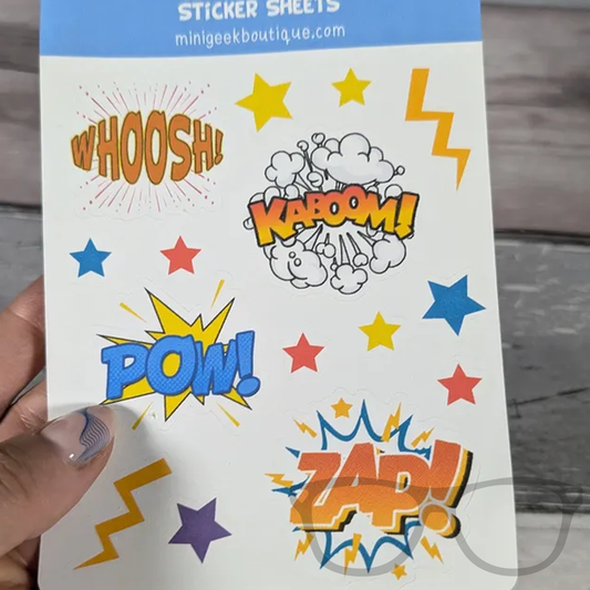 Sticker sheet featuring comic sounds like Pow, Zap, KABOOM, and Woosh, held in hand, perfect for decorating notebooks, journals, and reward charts.