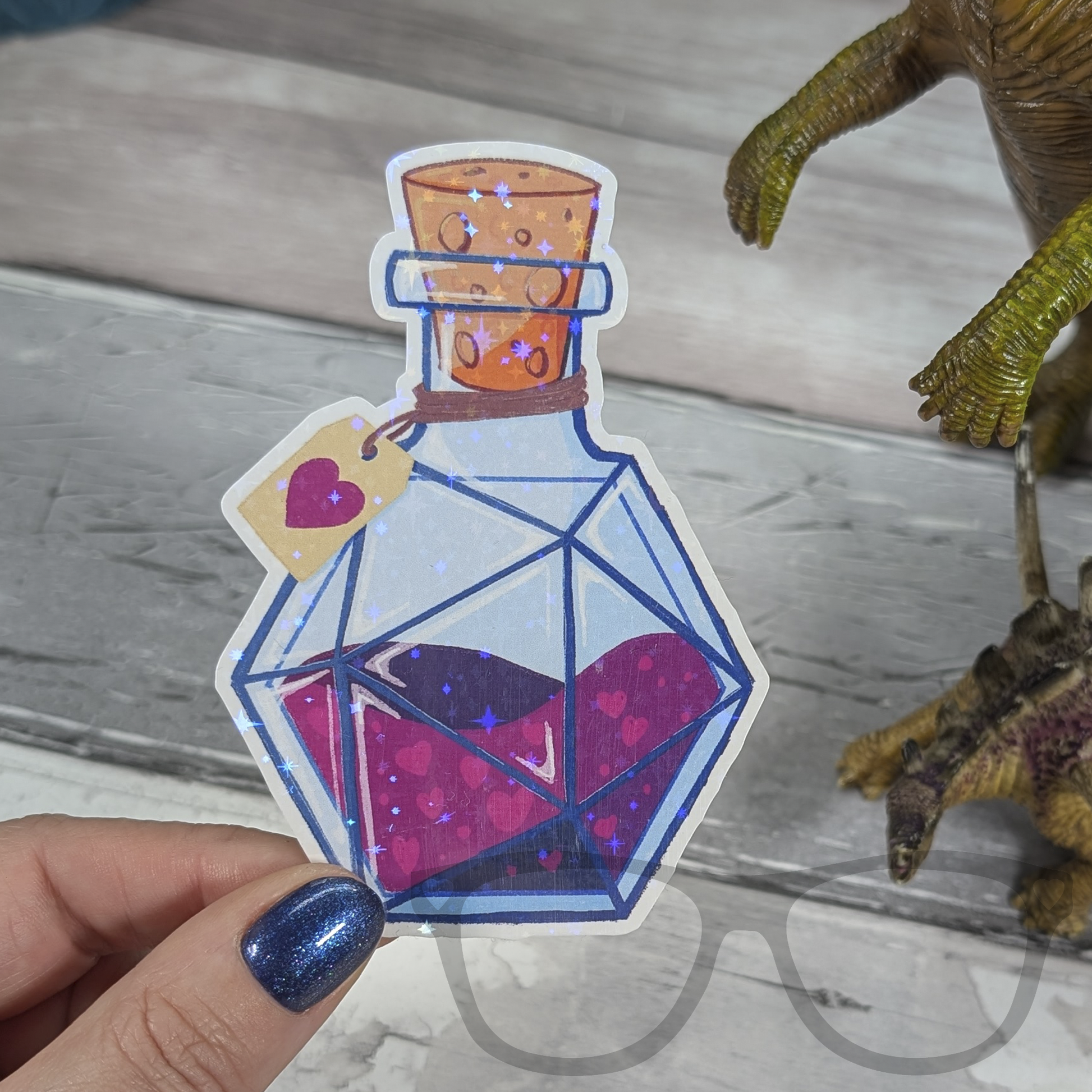 Die cut sparkly potion sticker  included in the Dinos and Dice Bundle Box.