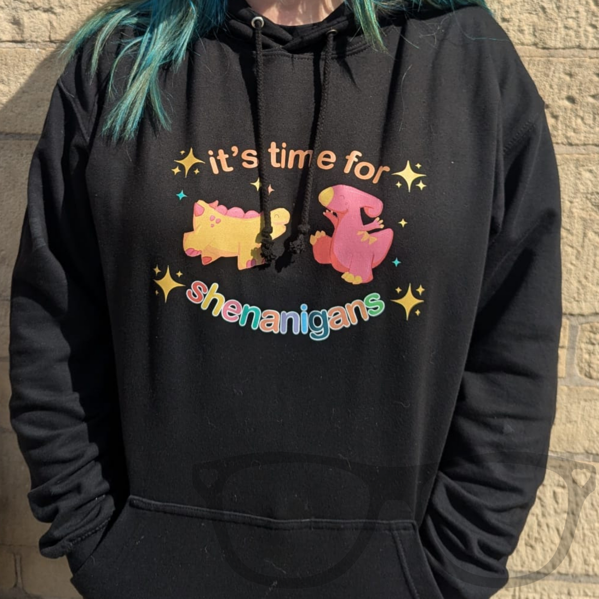 Geeky black hoodie for kids and adults with playful dinosaur design and front pocket