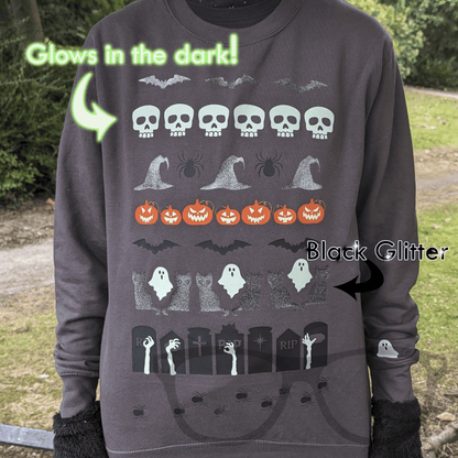 Grey Halloween Sweater with Glow in the Dark and Glitter Vinyl showing bats, skulls, witches hat, pumpkins with glow in the dark eyes, ghosts cats, gravestones, and spiders
- Mini Geek Boutique
Text reads "Glow in the dark" and "Black Glitter"
