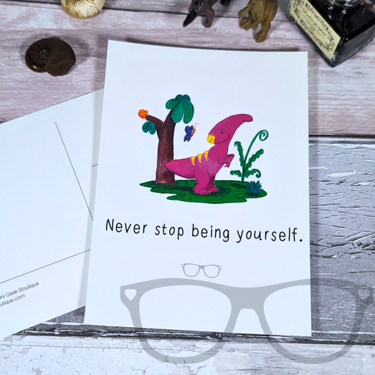 A6 postcard featuring Irene the Parasaurolophus with the phrase 'Never stop being yourself' on the front. The back is writable with space for a message and address.