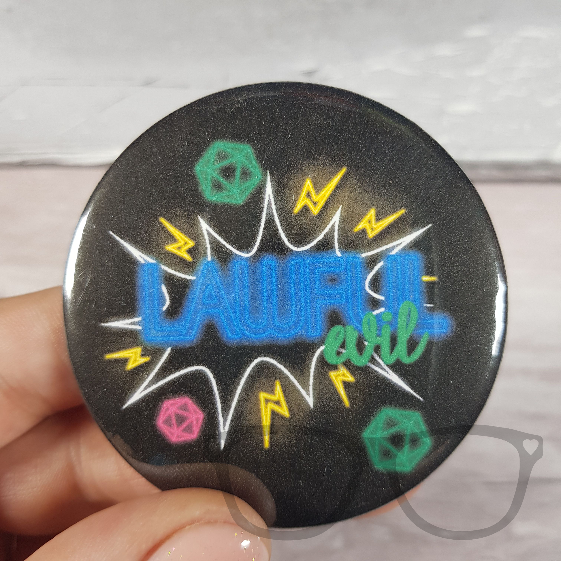 Lawful evil 58mm cyberpunk tabletop alignment badge. Black badge features a colour neon lights style. The words LAWFUL EVIL surrounded by dice and lightening bolts
