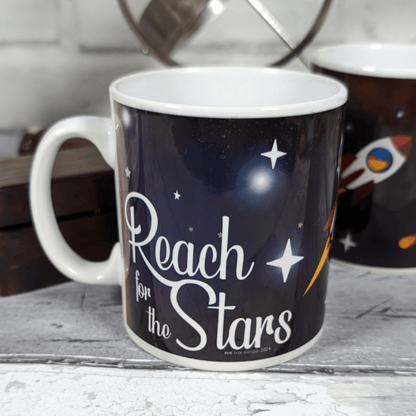Mug with 'Reach for the Stars' text on a space-themed background
