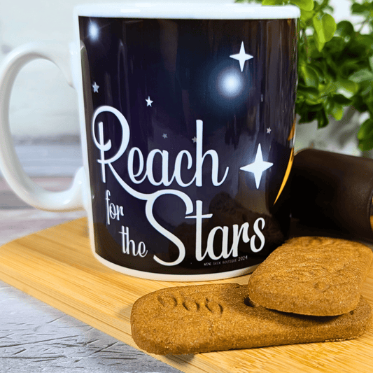 Mug with 'Reach for the Stars' text on a wooden board with cookies