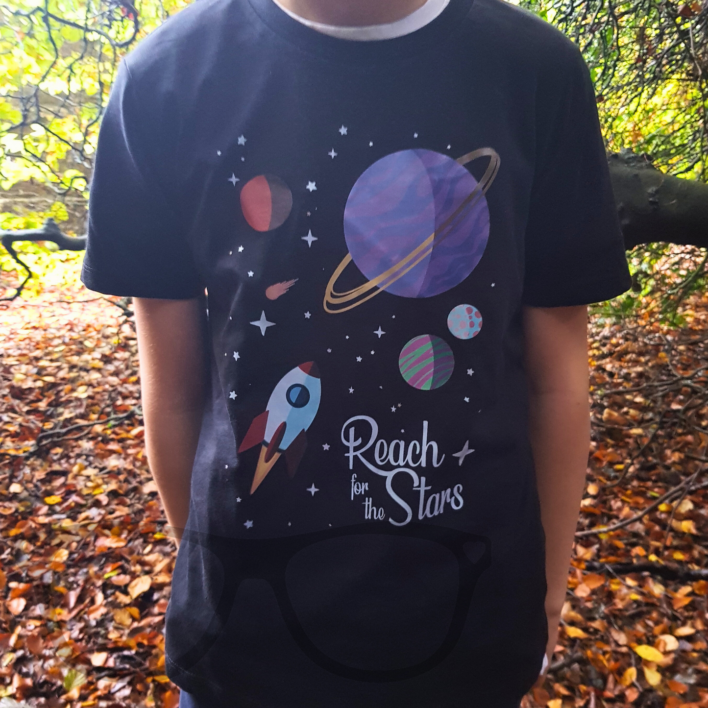 Reach for the stars space themed full colour design featuring a rocket in space on a black organic cotton t-shirt