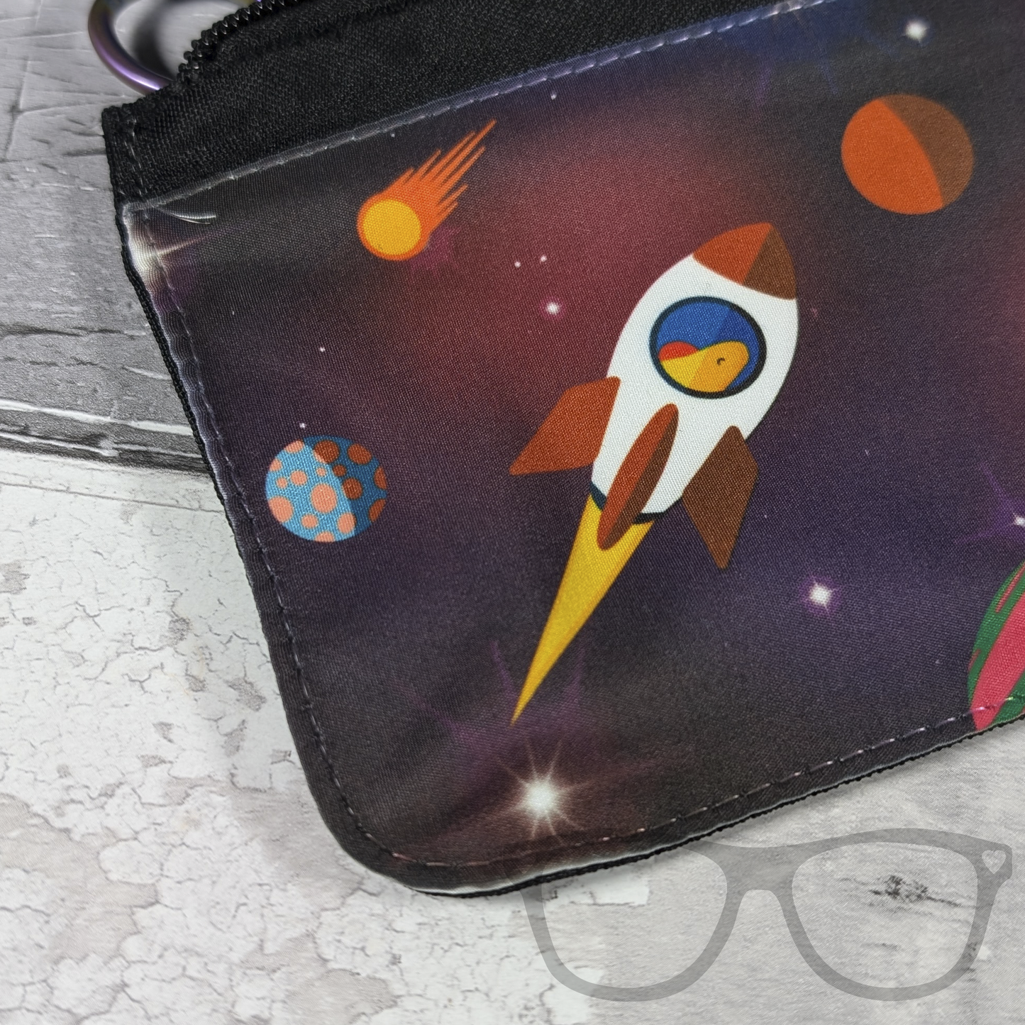 Close up detail of reach for the stars pencil case showing a dinosaur in a rocket
