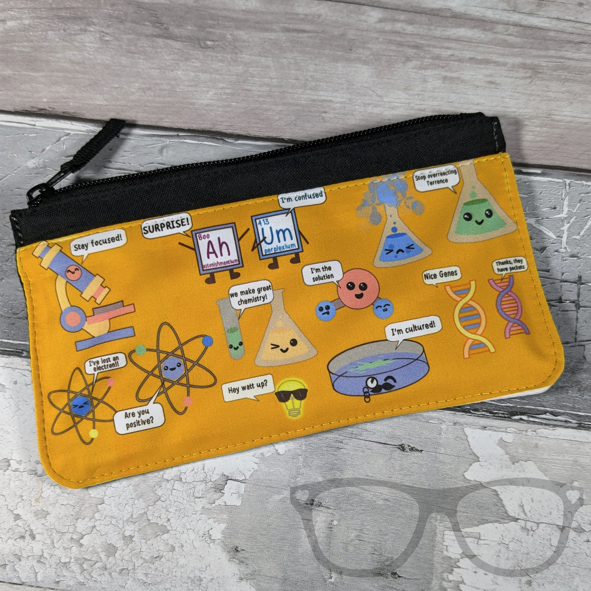 Science pencil case with cute illustration of science equipment and icons positive puns such as a microscope saying "Stay Focused" and an overreacting conical flask