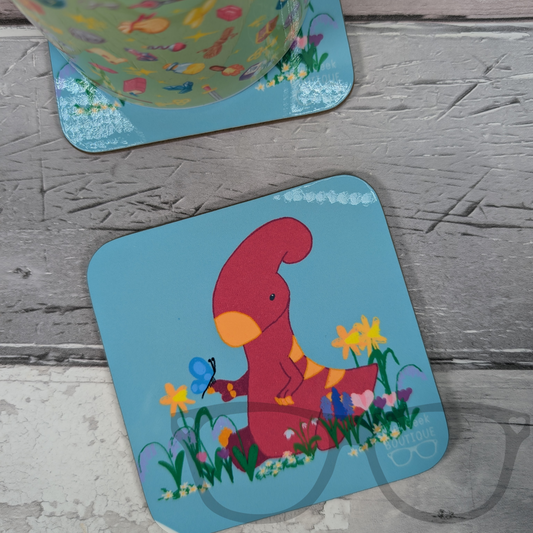 Irene the Parasaurolophus is surrounded by blooming spring flowers in this delightful 9cm square coaster. The soft, pastel design brings a peaceful, floral touch to any home décor.