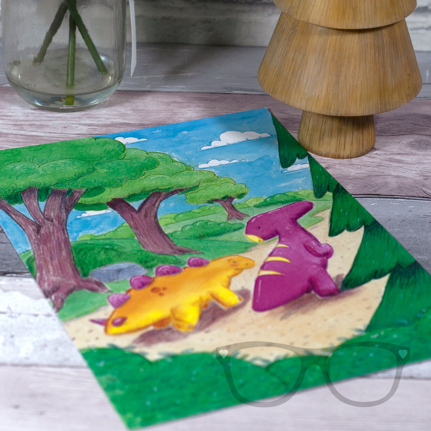 A4-sized dinosaur print with Derek and Irene, the whimsical dinosaurs, walking along a woodland path, designed using vibrant watercolours.