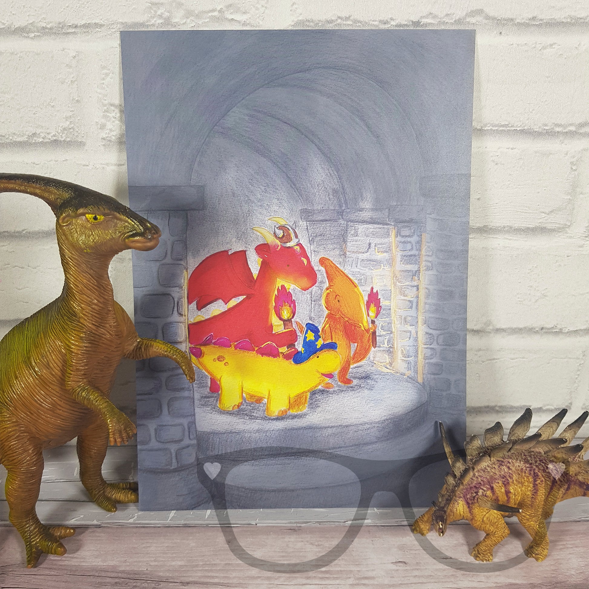 A4 Print "Lets go find the mystical donut" - Mini Geek Boutique. Derek and Irene the dinosaurs are standing next to the print which is leaning up against a white brick wall.