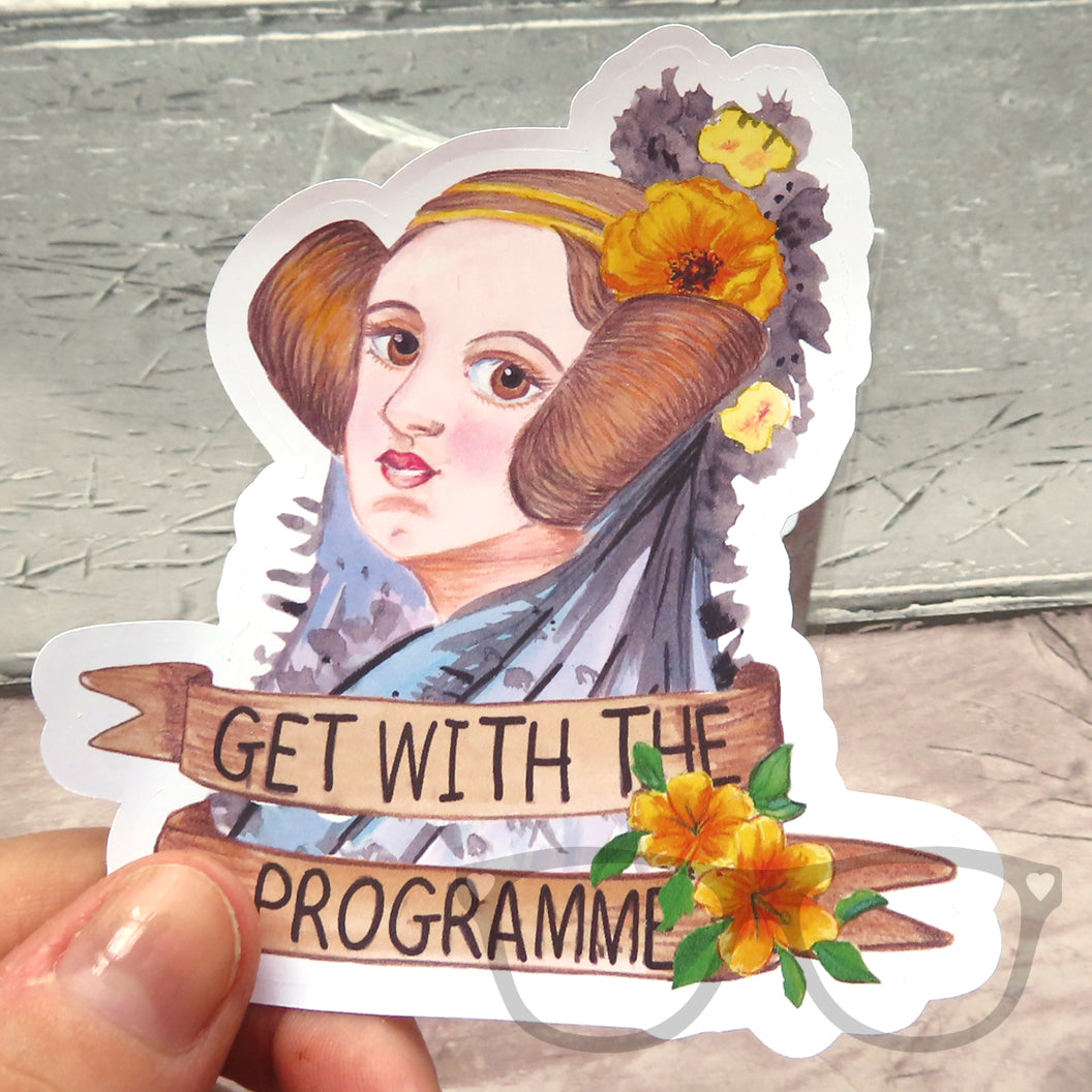 A close up of the portrait sticker of Ada Lovelace, the text reads "Get with the Programme in homage to Lady Lovelace's pioneering concept of computer programming.