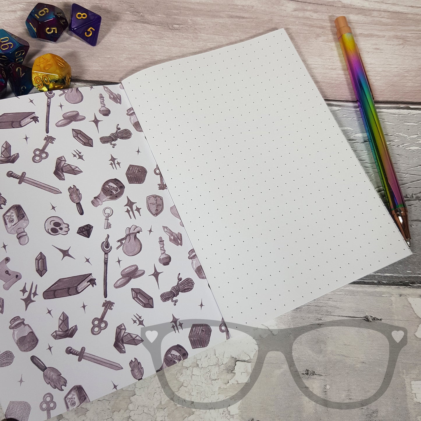 Open A6 notebook displaying inside cover and dotted pages, ideal for sketching, mapping, or taking notes during tabletop games.
