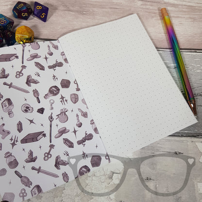 Open A6 notebook displaying inside cover and dotted pages, ideal for sketching, mapping, or taking notes during tabletop games.