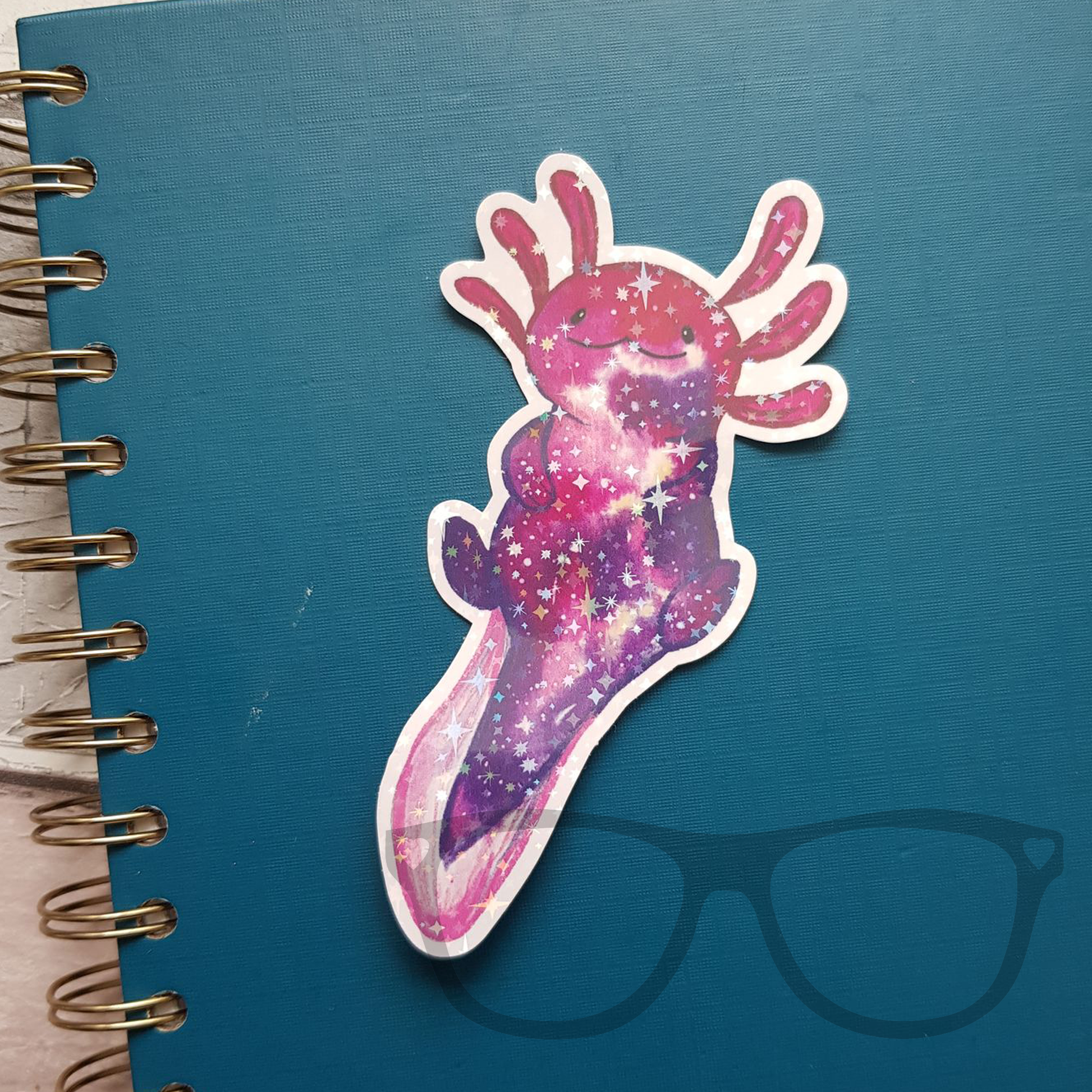 Axolotl space sticker with star sparkles on notebook