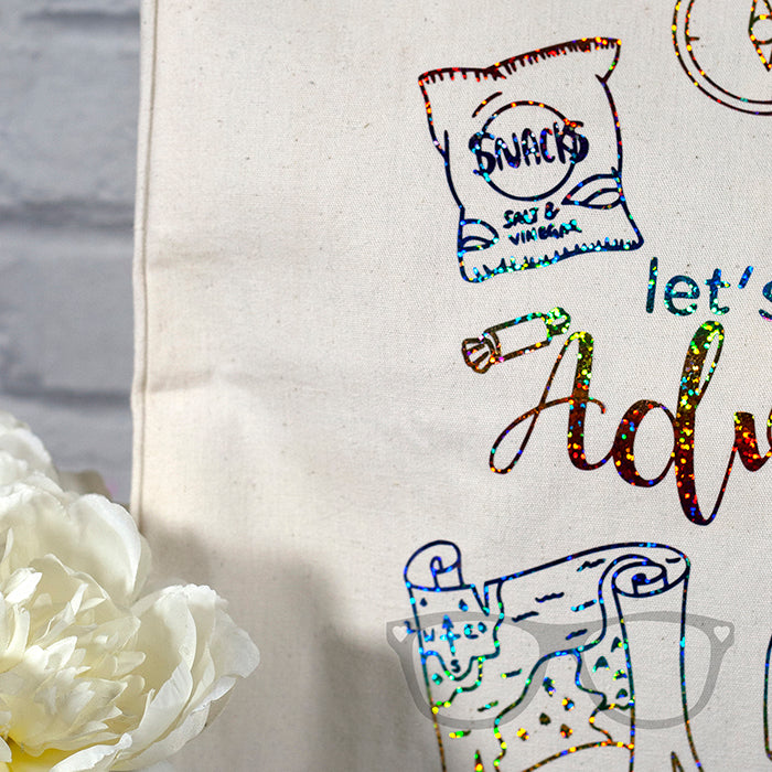 Limited Edition Canvas Tote bag with rainbow foil design "Let's go on an adventure" Close up of design showing snacks and text