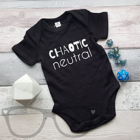 Black baby body suit with poppers, the white text on the front reads "Chaotic Neutral". The baby suit has short sleeves and poppers around the legs, with envelope collar for those unfortunate accidents. Great for geeky new parents who understand how chaotic babies can be.