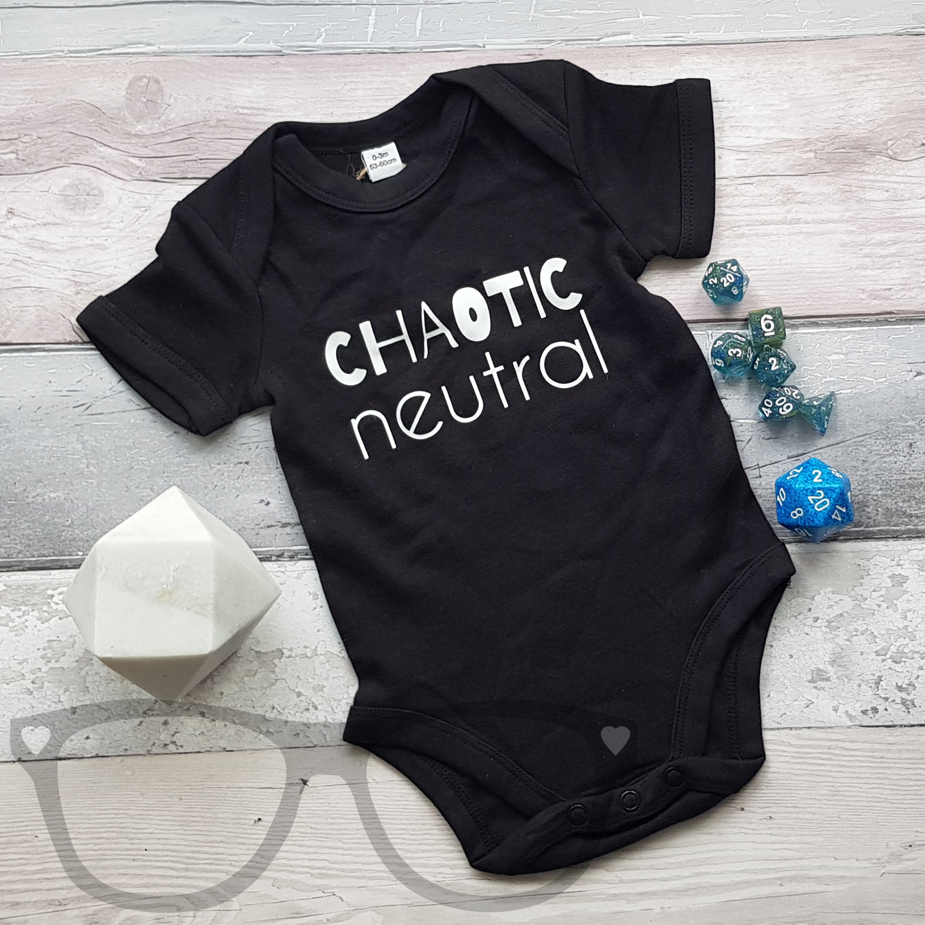 Black baby bodysuit with short sleeves and 'Chaotic Neutral' text on front, featuring envelope collar and popper leg closure for easy changing.