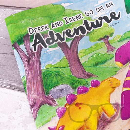Close-up of Dinosaur Adventure Zine Issue 1 cover, highlighting vibrant illustrations of Derek and Irene on their adventure, designed for kids with a fun story and activities.