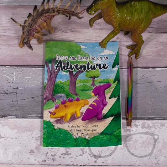 Front cover of Dinosaur Adventure Zine Issue 1, featuring colourful illustrations of Derek and Irene, with a fun story, colouring page, and puzzles for kids.