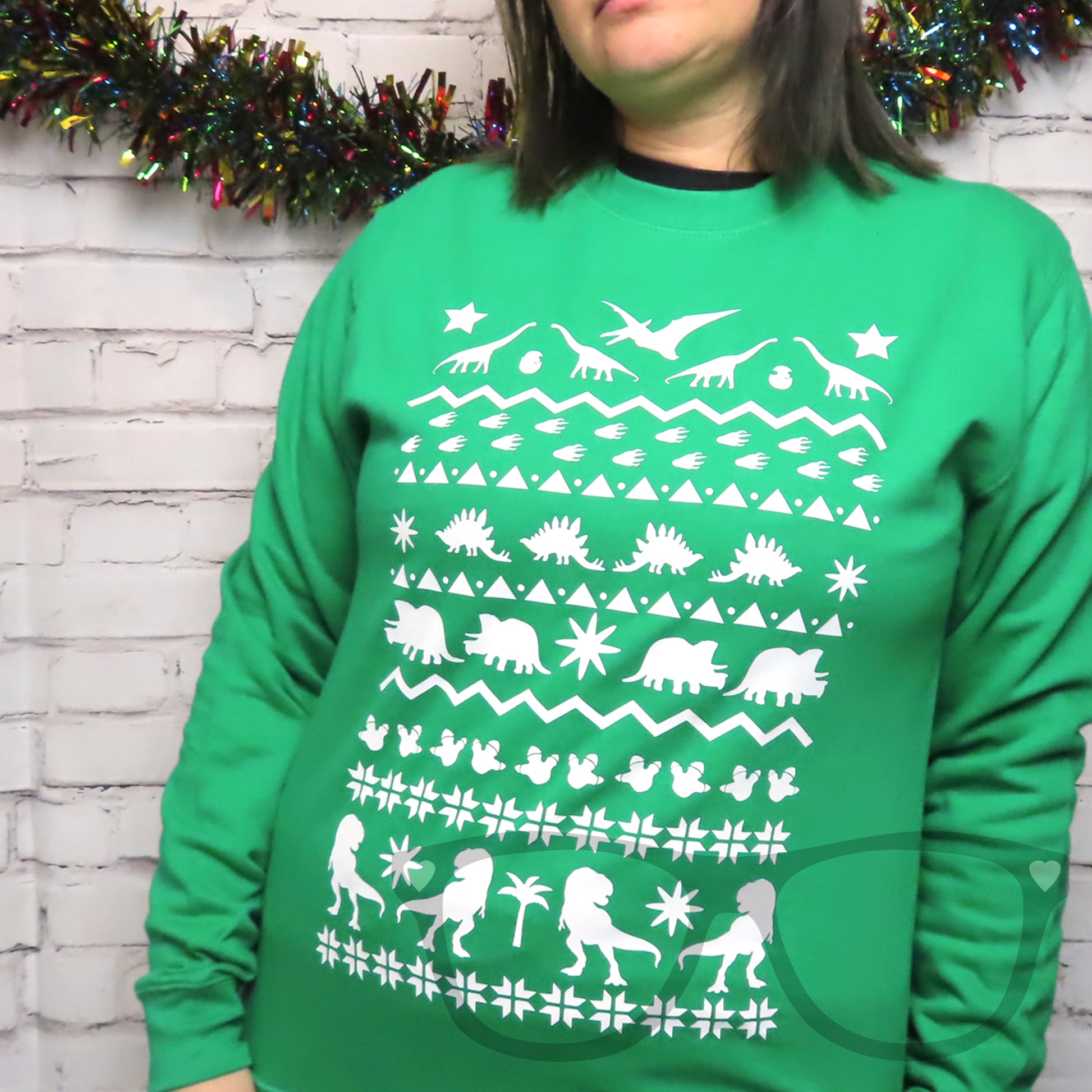 Green sweater with white dinosaur design ideal for the christmas and festive period