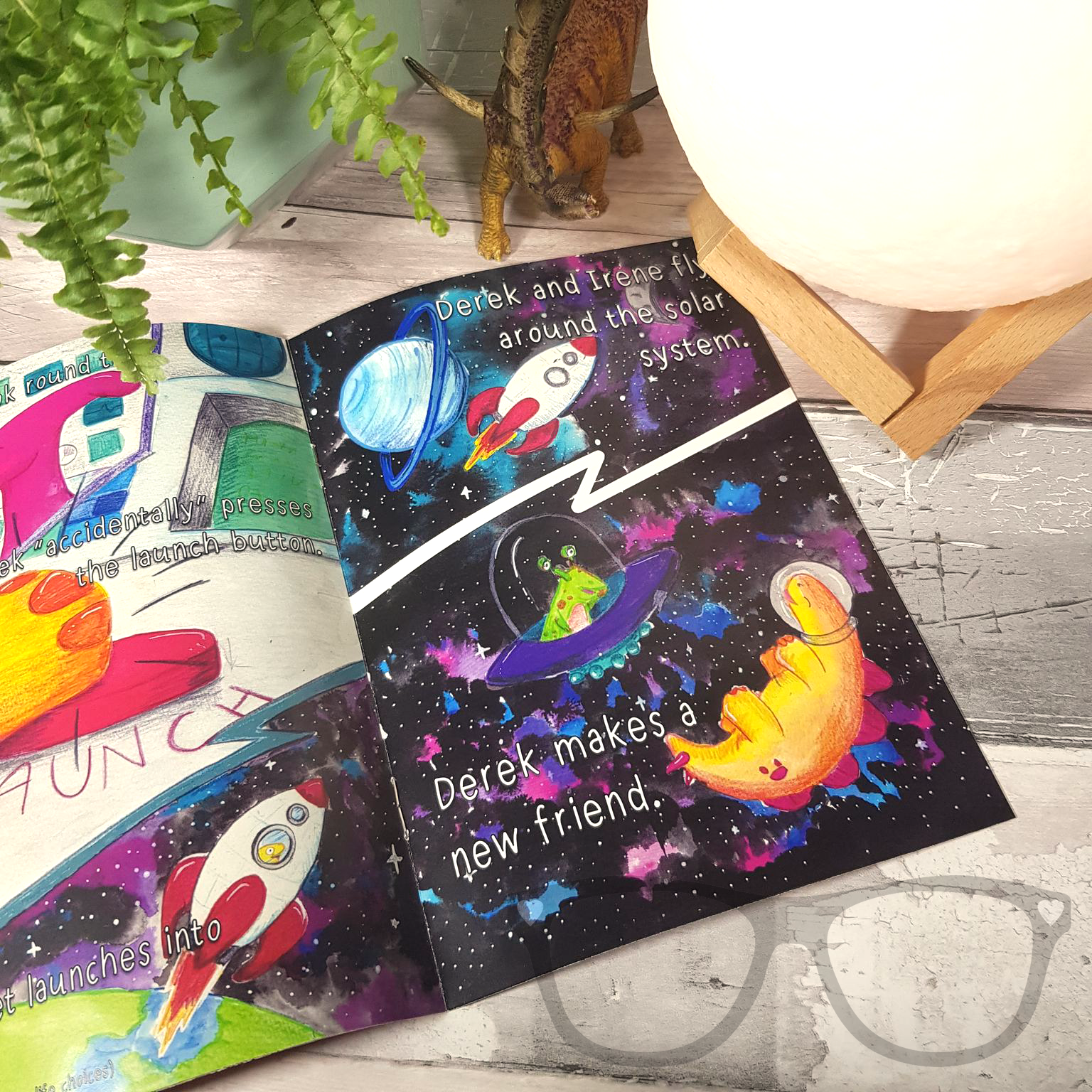 Open pages of Issue 3 of the Derek and Irene zine, featuring the space adventure story with colourful illustrations of Derek and Irene in a rocket.