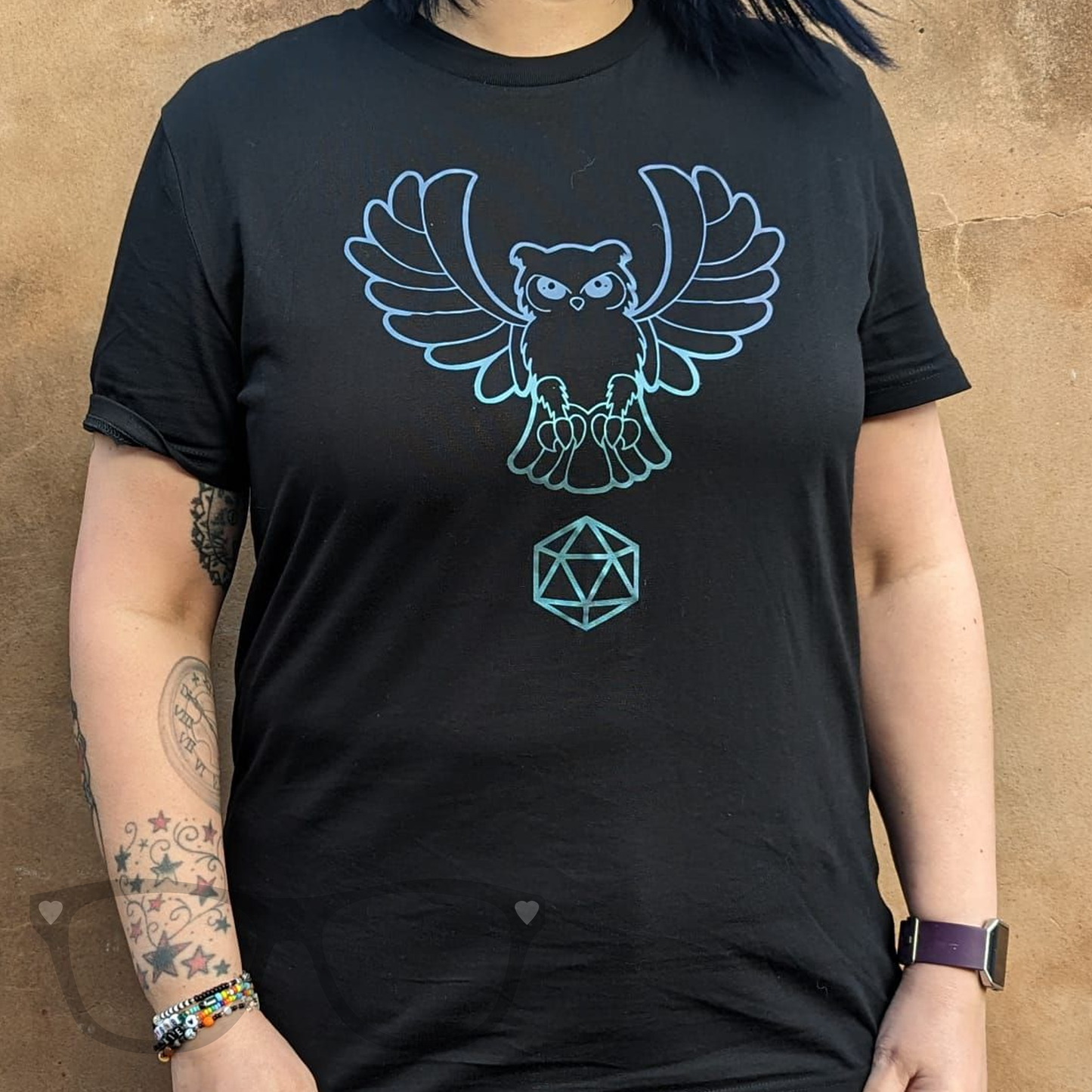 Owl wisdom t-shirt on black organic cotton t-shirt being worn